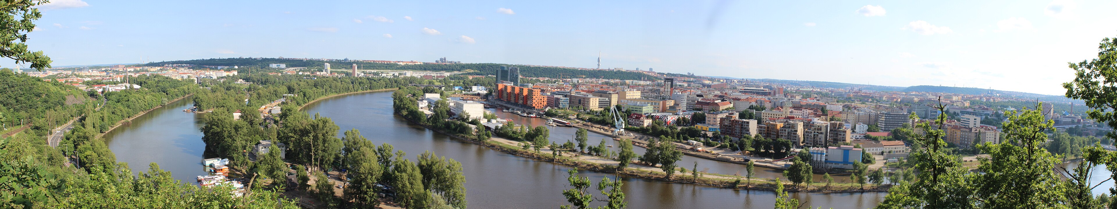 The waterfront built out — the tower no longer standing alone.